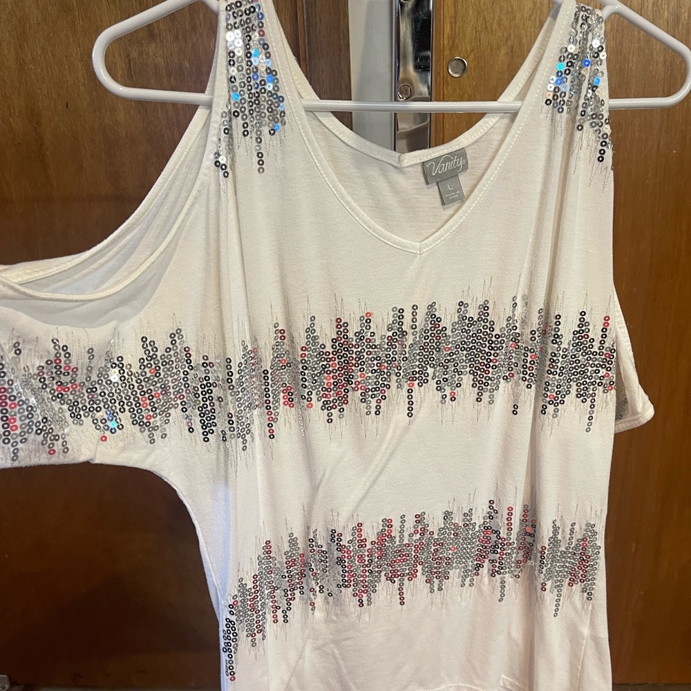 White with silver sequins on the shirt and open on the sleeves